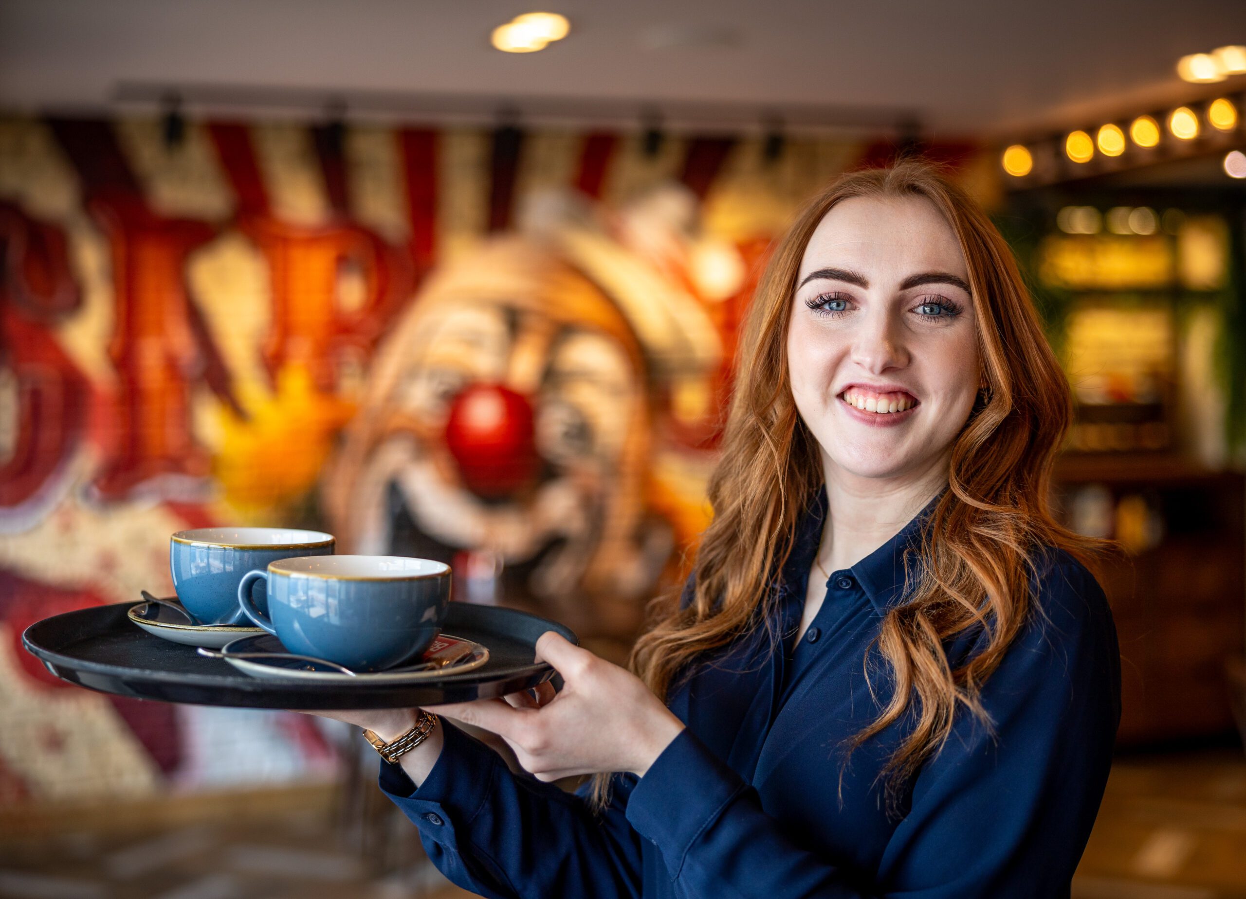 Server at Walterz with a tray of Coffee